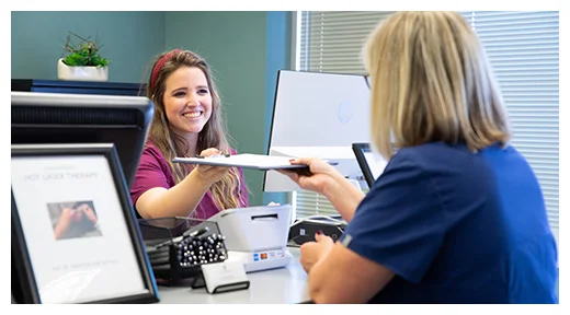 Chiropractic Olathe KS Receptionist Greeting A Patient