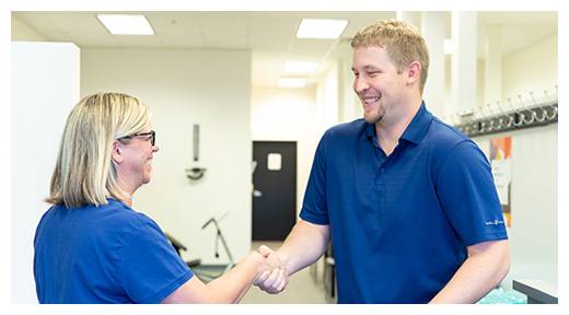 Chiropractor Olathe KS Devin Morton Greeting A Patient